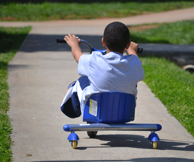 boy on a toy bike